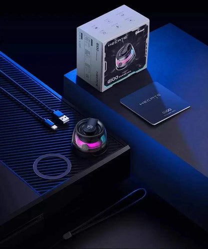 Hecate G100 Magnetic Wireless Bluetooth Speaker Subwoofer setup with packaging and accessories in a tech-themed setting.